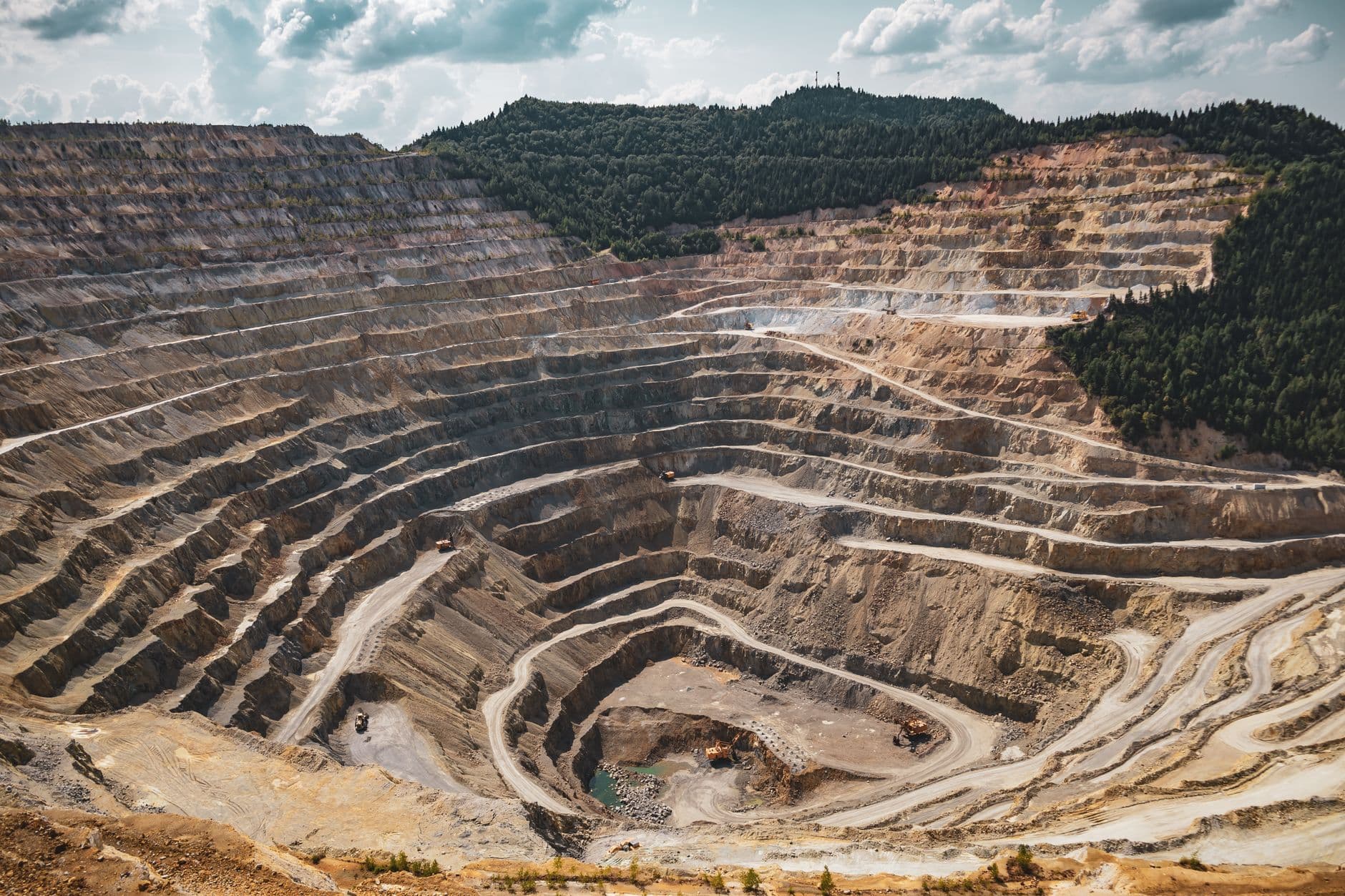Aerial view of a terraced open-pit mine.